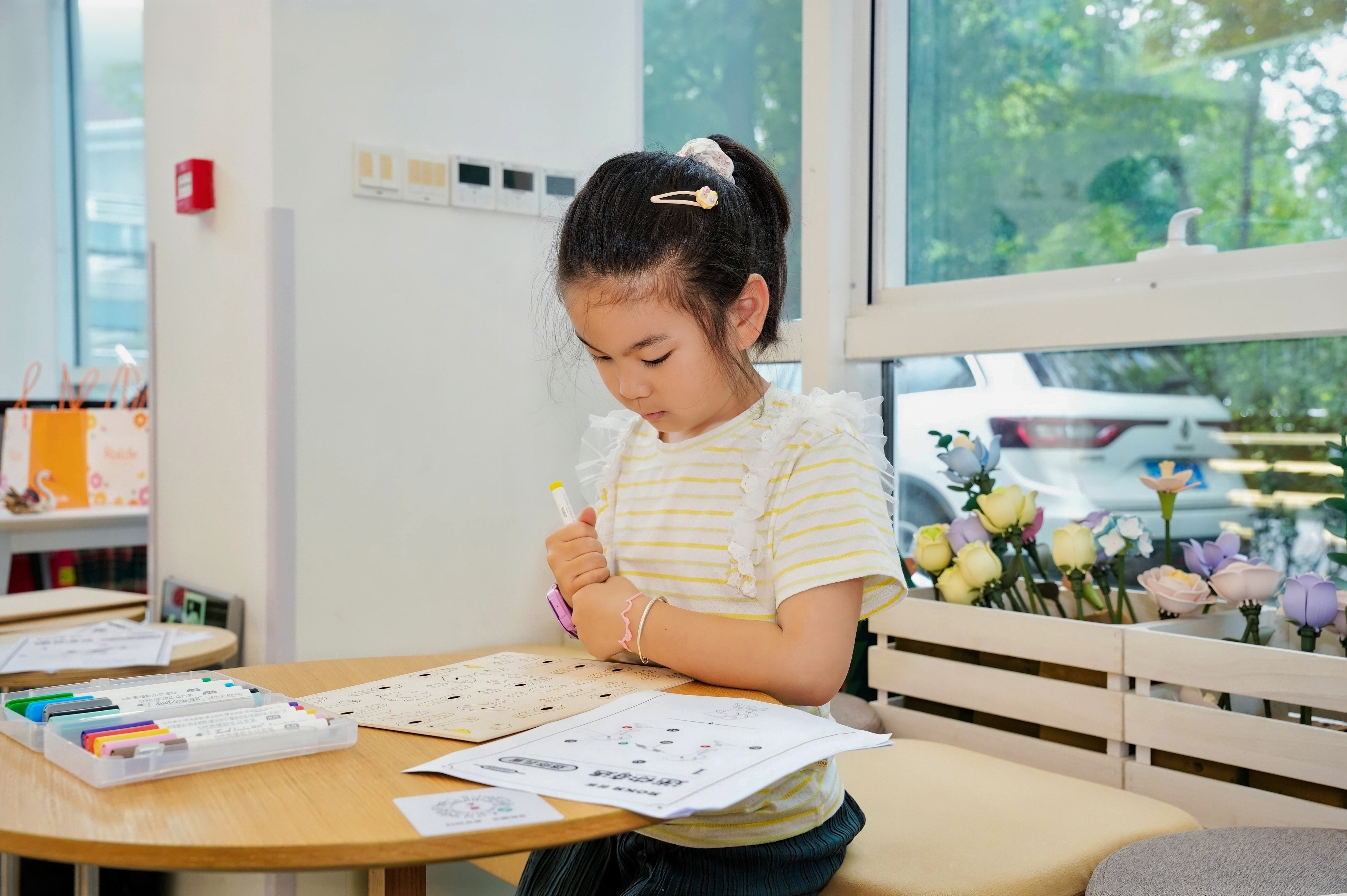 Child creating a dragonfly model