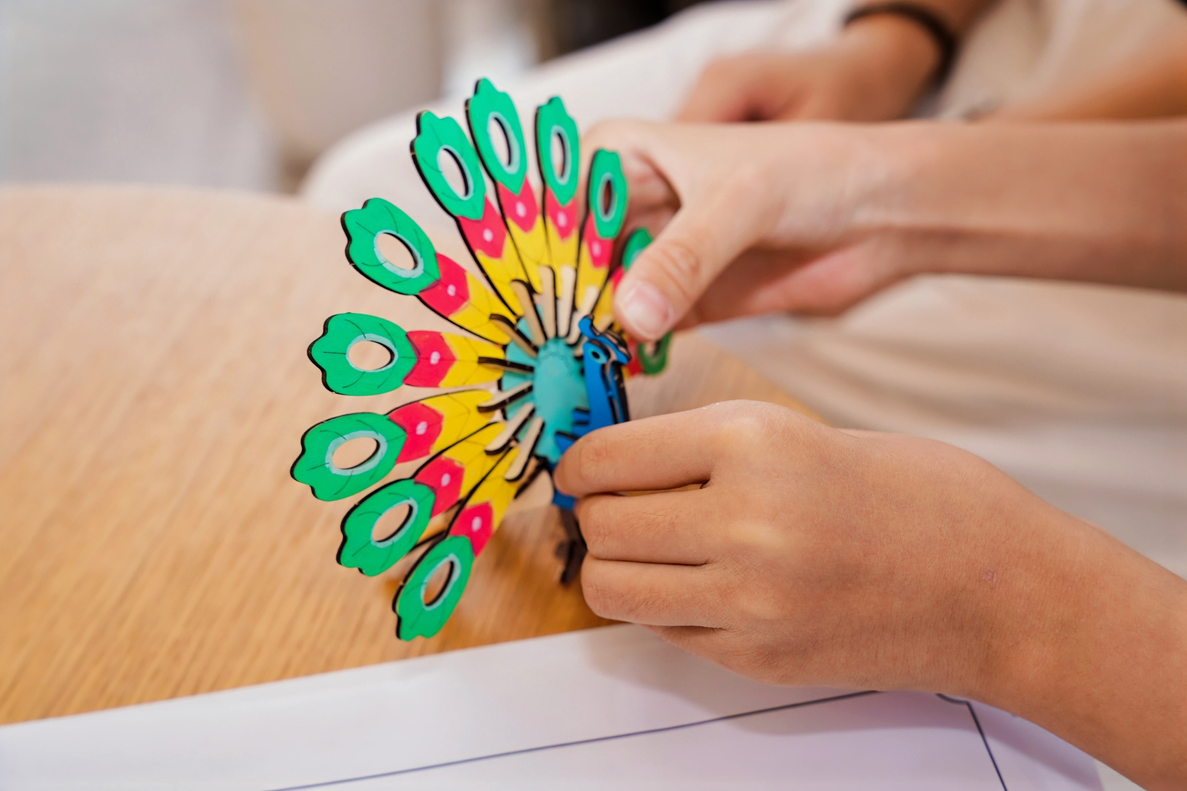 Close-up of a child coloring a handmade model