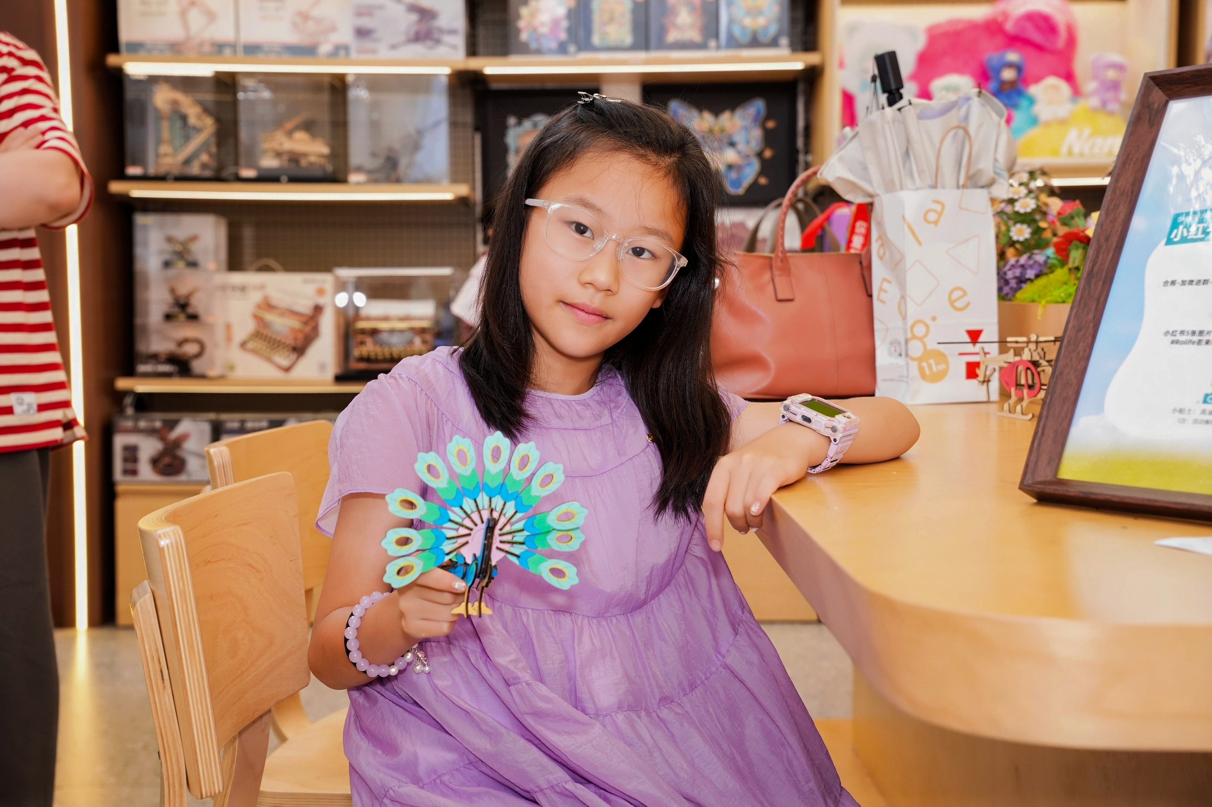 A young participant holding her finished Focalab model